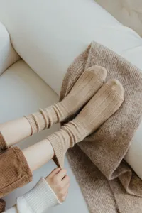 Detail view of cozy women wool slouch socks in vintage brown, soft ribbed mid-tube winter wear.