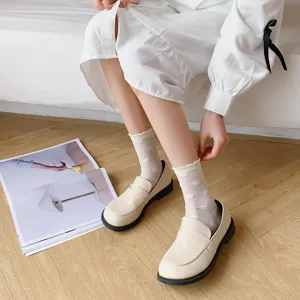 White JK style cute sweet mid-calf socks paired with classic leather loafers detail view