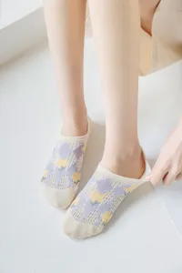 Detail of women mesh low-cut boat socks with purple argyle and yellow floral pattern.