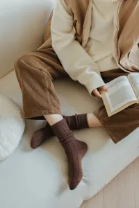 Brown ribbed wool socks detail view showing cozy retro winter style worn with corduroy pants.