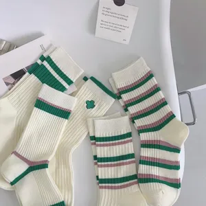 Detailed close-up view of Japanese style striped mid-calf socks with clover embroidery.