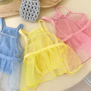 Detailed view of cute pet mesh dresses in pastel colors, featuring dotted ruffle design.