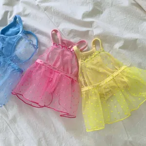Detailed close-up of colorful mesh pet strap dresses in blue, pink, and yellow.