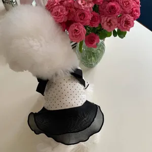 Close-up detail of a cute pet dog dress featuring polka dot top, black mesh skirt and bow decor.