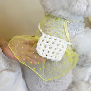 Detail shot of cute pet mesh dress with floral pattern and mini crochet bag accessory.