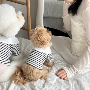 Detail view of striped pet dog clothes with white collar for small dogs, comfortable daily wear.