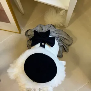 Detailed top view of chic black and white pet dress with bow and mesh skirt for dogs and cats.