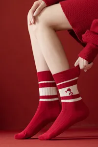 Red knitted women mid-tube socks with cute snake embroidery, cozy seasonal footwear detail.
