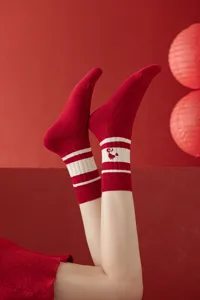 Red knitted mid-tube socks with white stripes and cute embroidery for year of snake women.