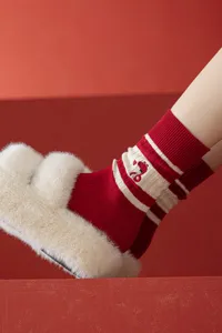 Red knit mid-tube socks with cute snake embroidery and white stripes for cozy winter.