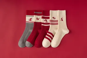 Detailed view of Year of the Snake red knit mid-tube socks with cute snake embroidery.