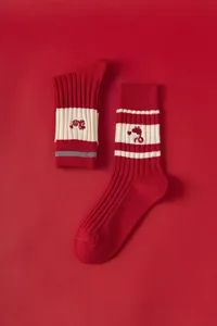 Red knit mid-tube socks featuring cute snake embroidery and stylish white stripes design.