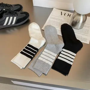 Close-up detail of Japanese JK style mid-calf socks with three sporty stripes, soft knit fabric.