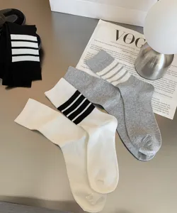 Detail view of Japanese JK style mid-calf socks with classic three-stripe design for women