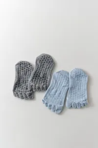 Detailed view of non-slip yoga five toe socks with silicone dots for women fitness.