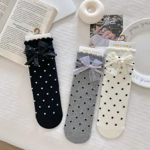 Sweet polka dot lace bow mid-tube socks detail display, featuring delicate ruffles and charming styles.
