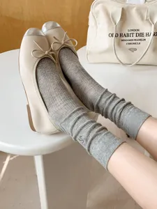 Ribbed knit bow embroidered ruffle socks paired with stylish ballet flats, breathable summer wear.