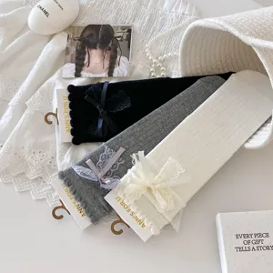 Cute women crew socks featuring delicate lace bows and ruffle cuffs, perfect for sweet JK styles.
