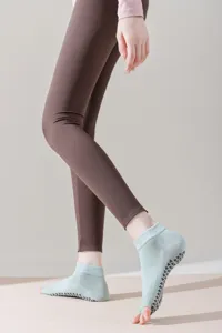 Close-up view of open-toe yoga socks with anti-slip silicone grip soles for women workout.