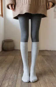 Detail view of thick thermal knee-high socks in a cozy retro style, lifestyle shot.
