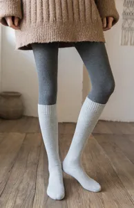 Detailed view of winter warm solid color long calf socks worn with leggings for cozy daily wear.