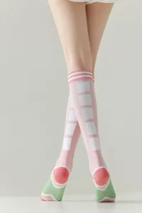 Close-up detail of cute watermelon design knee high socks, pink and green fashionable women hosiery.