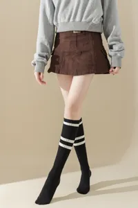 Detailed shot of black knee-high socks featuring stylish white stripes for women.