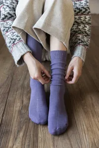 Detail shot of solid color thick loop knit socks, cozy thermal winter crew sock texture.