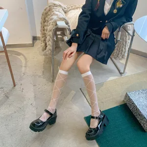 Japanese style white translucent diamond pattern knee high socks detail shot showing leg wear.