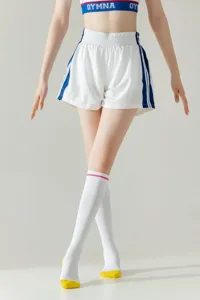 Detailed view of white knee high socks featuring pink stripe and yellow toe heel accents.