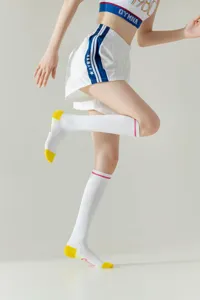 White long sports socks detail view, showing knee-high trendy athletic design for women.