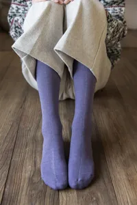 Close-up detail of cozy winter thermal knit knee high socks for women, vintage solid color.