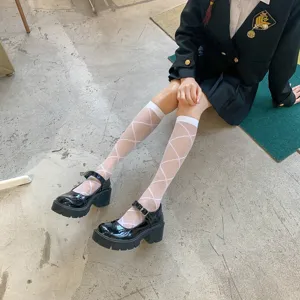 Japanese style sheer diamond pattern knee high socks with black platform shoes for women.