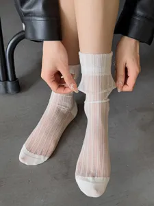 Close-up of sheer summer white ice silk slouch socks, showing transparent mesh and elastic cuff.