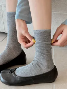 Detailed view of solid color split toe cotton socks, comfortable mid calf two toe design.