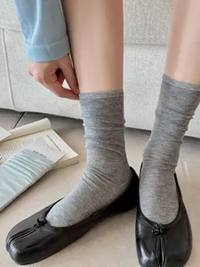 Detailed close-up shot of breathable solid color split-toe mid-tube socks in classic gray.