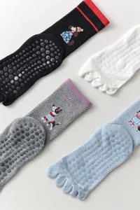 Women five-finger yoga socks with non-slip silicone grip and cute dog cartoon designs.