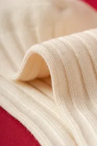 Knit ribbed socks fabric detail macro close-up view showing soft texture and cozy feel.