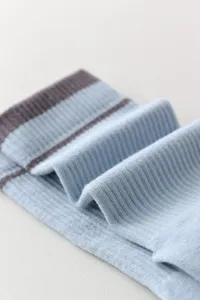 Close-up detail of soft ribbed striped knit socks showing fabric texture and stretch quality.