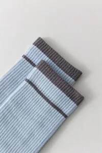 Detailed view of women's ribbed crew socks in light blue with dark striped cuffs