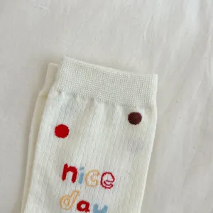 Cute women mid socks knit detail, white polka dot design, soft cotton fabric texture close up