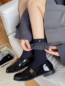 Women blue-grey mid-calf socks featuring plaid ruffle cuffs and elegant pearl decor.