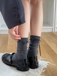 Women grey ribbed mid-calf socks featuring elegant blue ribbon bows, cute JK style.