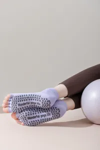 Close-up detail of open-toe yoga socks featuring non-slip silicone grips and split toes.