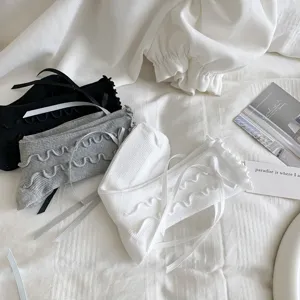 Close-up detail of sweet ruffle bow mid-tube socks in black, grey and white for cute JK style.