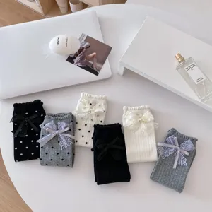 Sweet cute women mid-calf socks set with polka dots lace bows, aesthetic flat lay detail.
