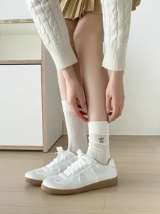 White sheer mesh mid-tube socks featuring cute bow embroidery for sweet ballet style.