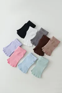 Multi-color open-toe yoga socks detail, soft ribbed knit texture for grip and practice.