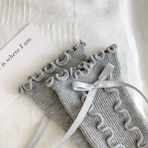 Grey ruffle bow socks detail view, sweet JK Lolita mid-calf cute socks close-up.