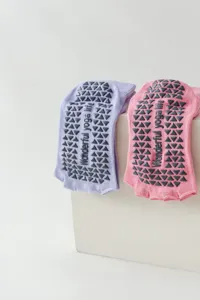 Open-toe yoga socks with non-slip silicone grips, breathable five-toe pilates socks for women.